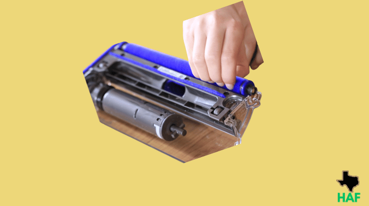 Installing new brush roller in vacuum